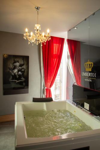 um quarto com uma banheira cheia de água ao lado de uma janela em BeB Umberto I Napoli em Nápoles