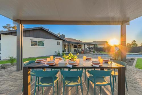 een patio met een houten tafel en stoelen bij El Parque Tempe in Tempe