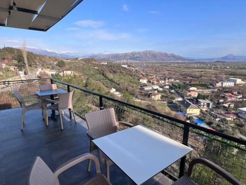a balcony with tables and chairs and a view at Hotel I Pari in Shkodër