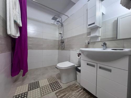 a small bathroom with a sink and a toilet at Hotel I Pari in Shkodër