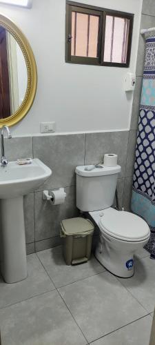 a bathroom with a toilet and a sink and a mirror at Casa Niño Peregrino Salinas in Salinas
