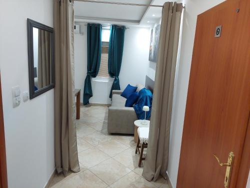 a living room with blue curtains and a couch at Apartments Nancy in Kotor