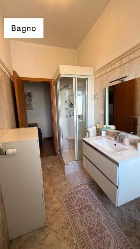 a bathroom with a white sink and a shower at Sweet Rome Ipogeo Degli Ottavi in Rome