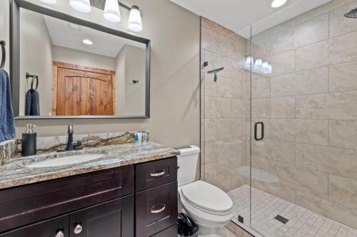 a bathroom with a shower and a toilet and a sink at Anchor Point in Rogers