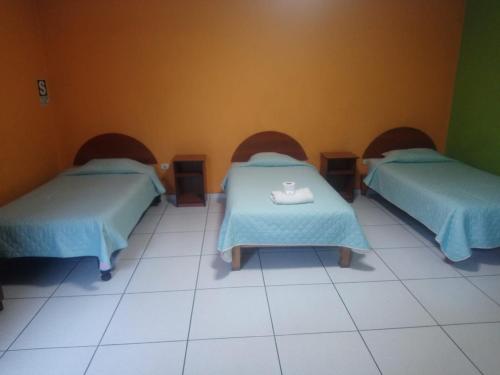 a room with two beds with a tray on a table at HOSTAL espinoza in Arequipa