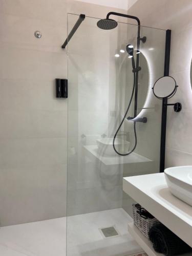 a glass shower in a bathroom with a sink at Apartamento Casa Nela in Medellín