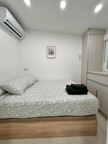 En eller flere senge i et værelse på AeroSuites103 Alojamiento Madrid