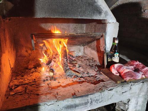 a brick oven with meat being cooked in it at La Clavelina in Potrerillos