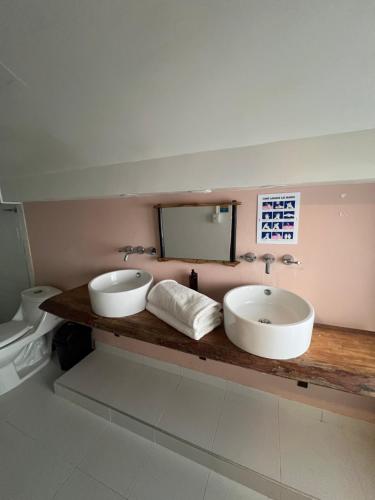 a bathroom with two sinks and a mirror at Hotel Las Marias by Croma in Palomino