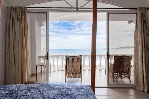 a bedroom with a view of the ocean at Sunset 303 - Ocean View 3 Br Condo in Tempate