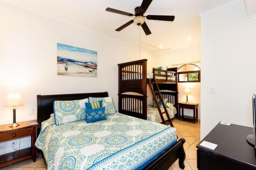 a bedroom with a bed and a ceiling fan at Sunrise 27- 2 Bedroom Ocean View Condo in Tamarindo