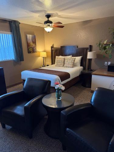 a hotel room with a bed and two chairs at Mountain View Lodge in Chelan
