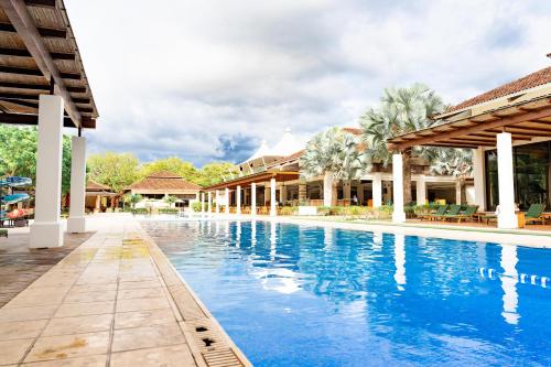 a swimming pool at a resort with blue water at Malinche 110-B, 1 Bedroom Condo At Reserva Conchal in Playa Conchal