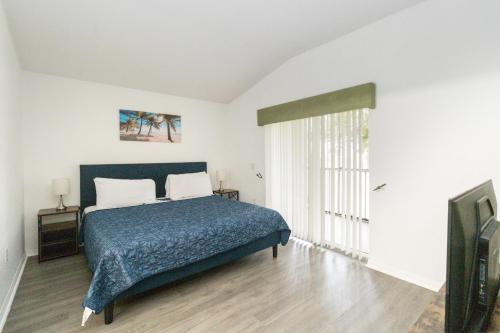 a bedroom with a bed and a tv in it at Huge Screened Patio That Overlooks Lake Buck, Near Famous Attractions!! in Orlando
