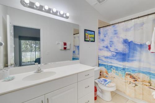 a bathroom with a sink and a toilet at Huge Screened Patio That Overlooks Lake Buck, Near Famous Attractions!! in Orlando