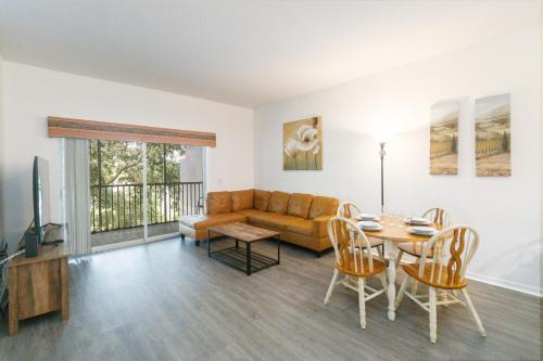 a living room with a couch and a table at Huge Screened Patio That Overlooks Lake Buck, Near Famous Attractions!! in Orlando