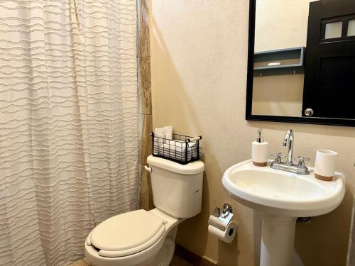 a bathroom with a toilet and a sink at Departamento #1 Loma Bonita in Loreto