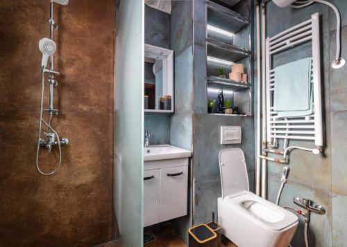 a bathroom with a toilet and a sink and a shower at Heart of the City - Free Parking in Pristina