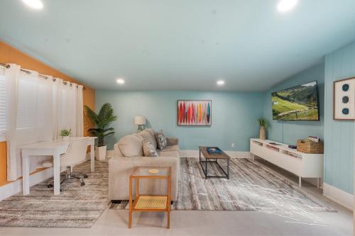 a living room with a couch and a table at Heated Pool, Lush Breezeway, Bikes, BBQ, Near Beach in Merritt Island
