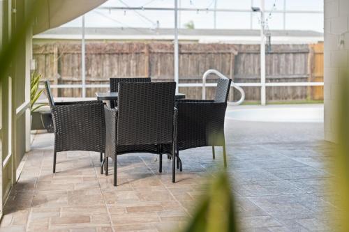 a group of chairs and a table in a room at Heated Pool, Lush Breezeway, Bikes, BBQ, Near Beach in Merritt Island
