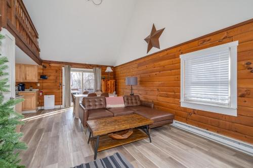 a living room with a couch and a table at Retrievers Retreat High Tech Log Cabin Oasis in Berkeley Springs