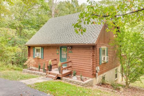 a log cabin with a porch and a blue door at Retrievers Retreat High Tech Log Cabin Oasis in Berkeley Springs