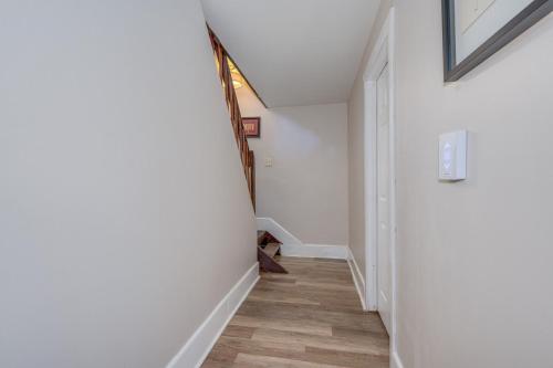 a hallway with white walls and wooden floors at Retrievers Retreat High Tech Log Cabin Oasis in Berkeley Springs