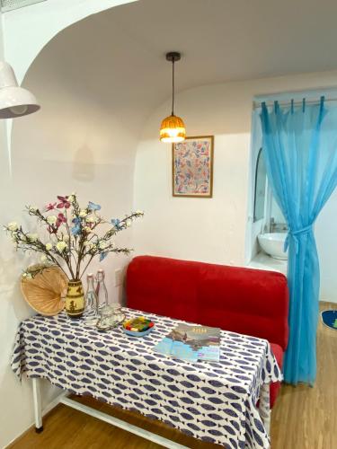 a red couch and a table in a room at VYA homestay Huế in Thôn Lại Thê