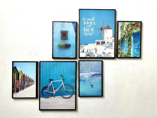 a group of pictures on a wall with a bike at VYA homestay Huế in Thôn Lại Thê