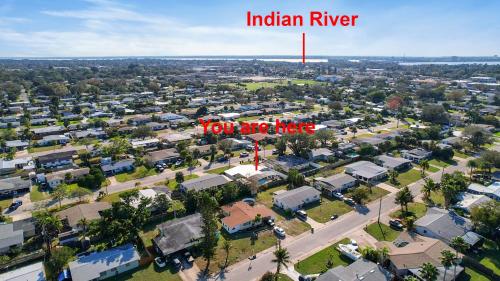 an aerial view of a town with a red sign that reads indian river at Heated Pool, Lush Breezeway, Bikes, BBQ, Near Beach in Merritt Island