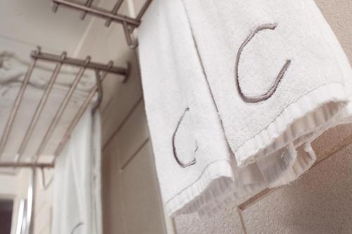 a towel is hanging on a rack in a room at Casa in Hong Kong