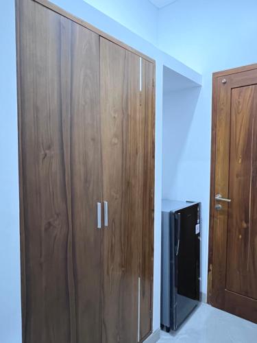 a pair of wooden cabinets in a room at Rauda Living Space Syariah in Pasuruan