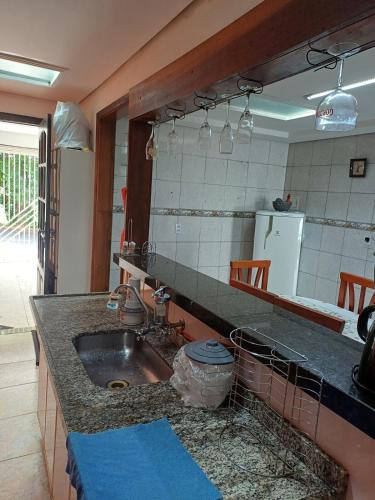 a kitchen with a sink and a counter top at Casa Master Bauru Com Ar Condicionado e Piscina in Bauru