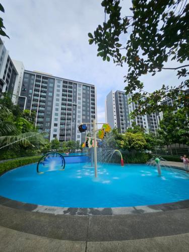 a playground with a water fountain in front of some buildings at SplashMania homestay Gamuda Cove in Banting