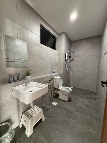 a bathroom with a sink and a toilet at 2BR Apartment Near Kuching Airport in Kuching