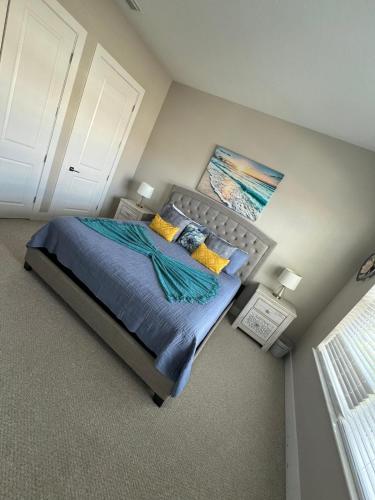 a bedroom with a bed with a painting on the wall at Disney here we go in Orlando