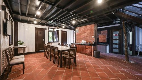 a kitchen and dining room with a table and chairs at Cameron Highland Retreat in Tanah Rata