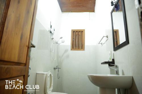 a bathroom with a sink and a shower and a toilet at The Beach Club in Wadduwa