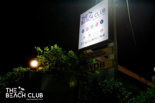 a sign on the side of a building with street signs at The Beach Club in Wadduwa