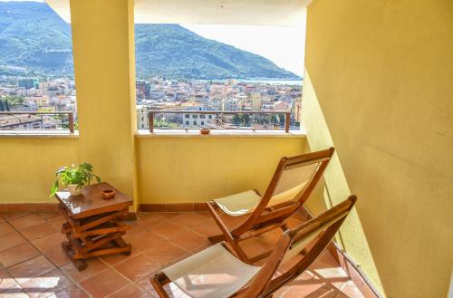 two chairs and a table in a room with a window at Bed & Breakfast Spigolatrice in Sapri