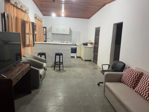 a living room with a couch and a table and a kitchen at DELPON Apart in Clorinda