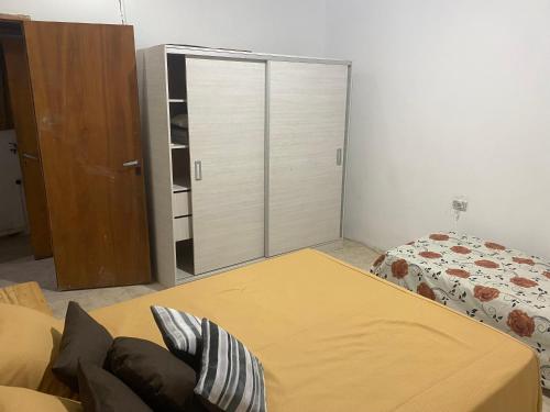 a bedroom with a bed and a sliding glass door at DELPON Apart in Clorinda