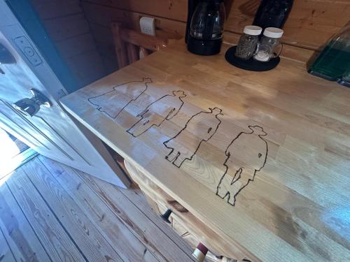 a drawing of a group of people on a table at Katie's Cozy Cabins in Tombstone