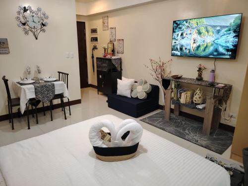 a living room with a bed and a dining room at Stylish New Studio at McKinley Hill BGC Free Netflix in Manila