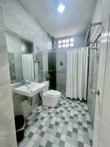 a bathroom with a toilet and a sink and a shower at Daddy Dream Hotel and Residence in Ranong