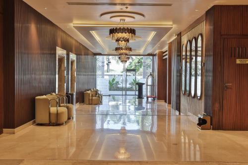 a hallway of a building with a chandelier at Royal Ritis in Belgaum