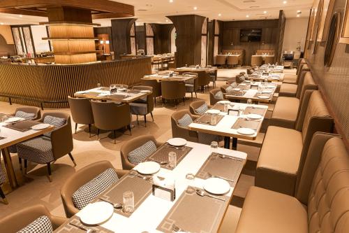 a dining room filled with tables and chairs at Royal Ritis in Belgaum