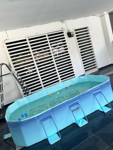 a blue table in front of a building at Ssue Klebang Ipoh Homestay With Complementary Pool & High Speed internet WIFI in Chemor