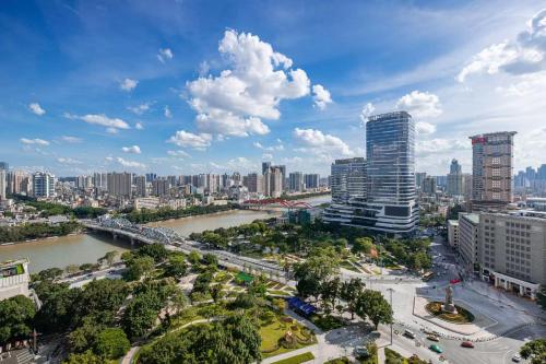a view of a city with a river and buildings at WAIFIDEN Guangzhou HaiZhu Square WanYi Apartment in Guangzhou