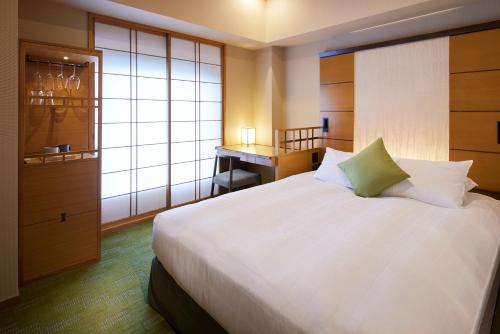 Ένα ή περισσότερα κρεβάτια σε δωμάτιο στο Hotel Niwa Tokyo